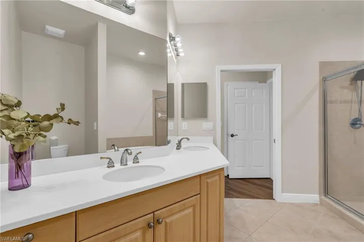 Bathroom with vanity and enclosed shower