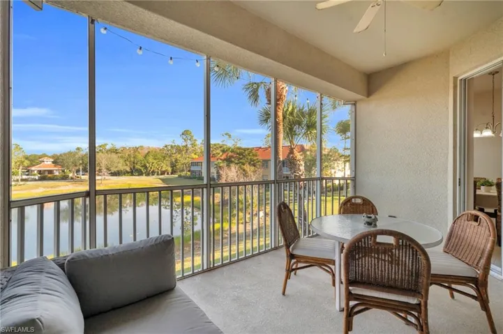 Screened lanai featuring a water view and ceiling fan
