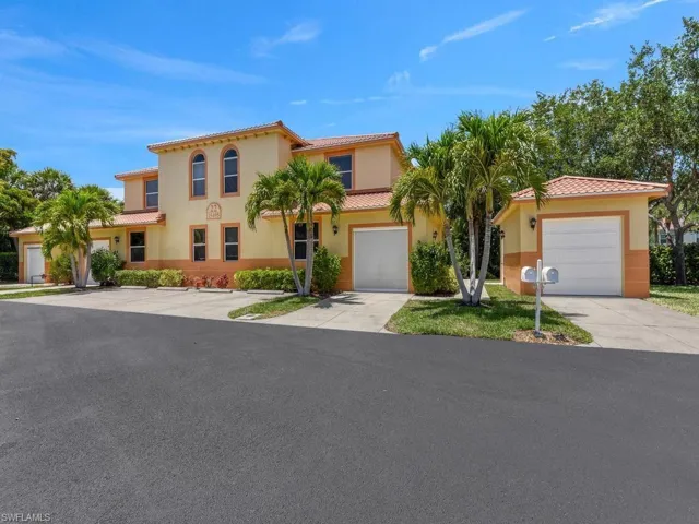 Multi-unit property featuring a stucco exterior with a tile roof
