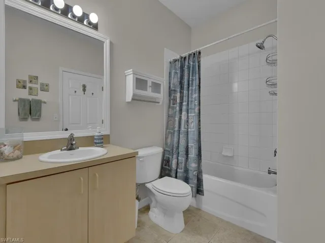 Full bathroom featuring a single vanity, a combination shower and bathtub, and a built-in medicine cabinet