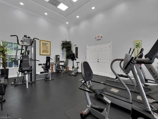 Recreational fitness area featuring multiple exercise machines, recessed lighting, and a neutral wall color