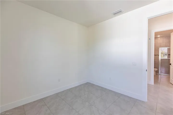Unfurnished room with visible vents, baseboards, and light tile patterned flooring