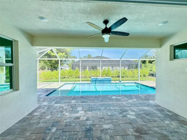 Pool with a lanai, a patio, and ceiling fan