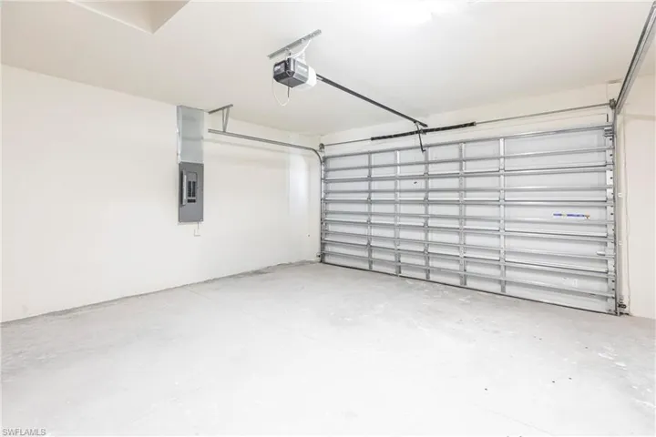 Garage with a garage door opener and electric panel