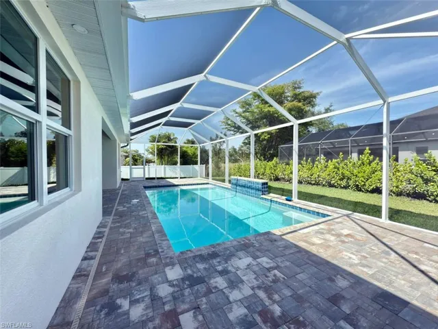 View of swimming pool with a lanai, a paver patio, and an enclosed