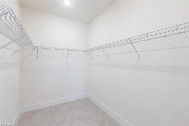 Walk in closet featuring light tile patterned floors