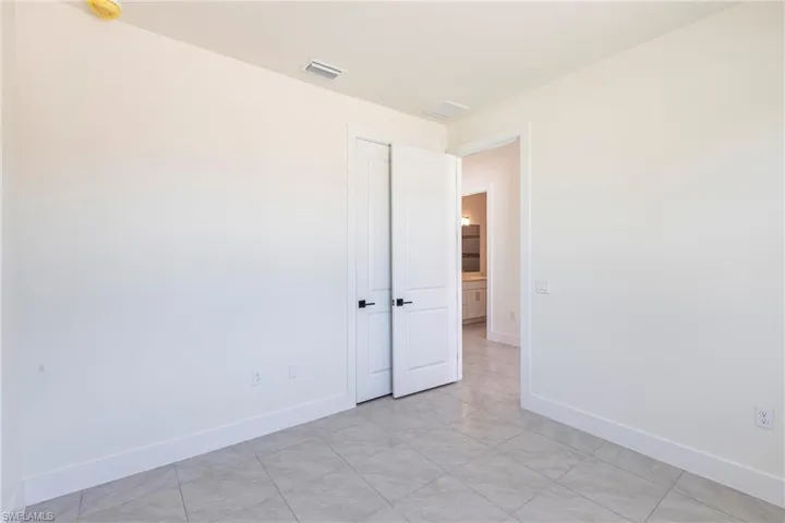 Empty room featuring visible vents and baseboards