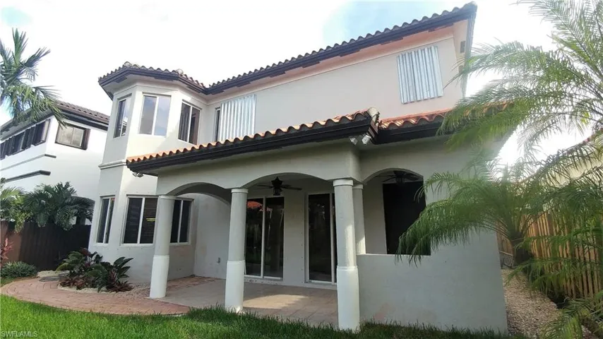 Rear view of home with brich paved Open Porch