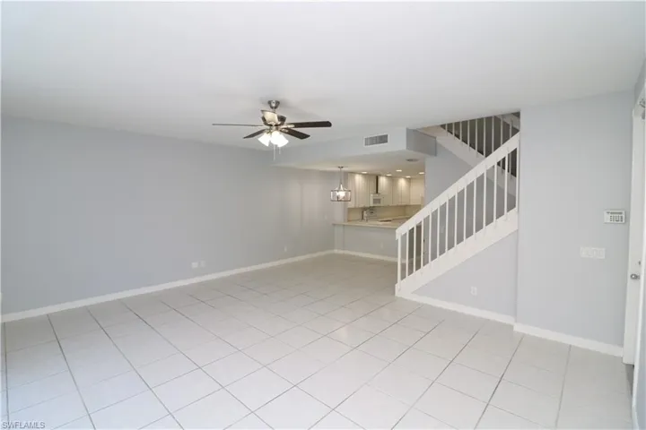 Tiled spare room with ceiling fan