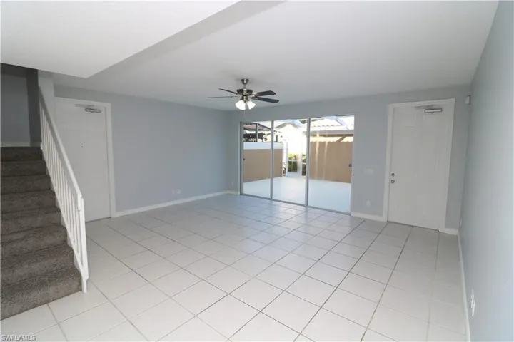 Spare room with ceiling fan and light tile floors