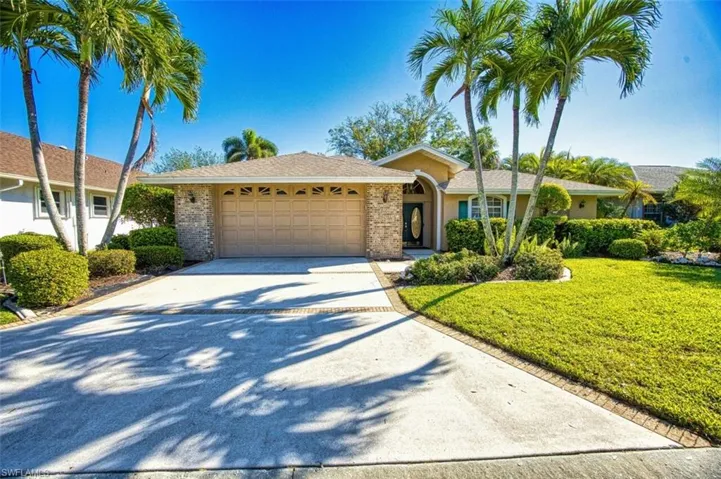 Single story home with a front yard and a garage