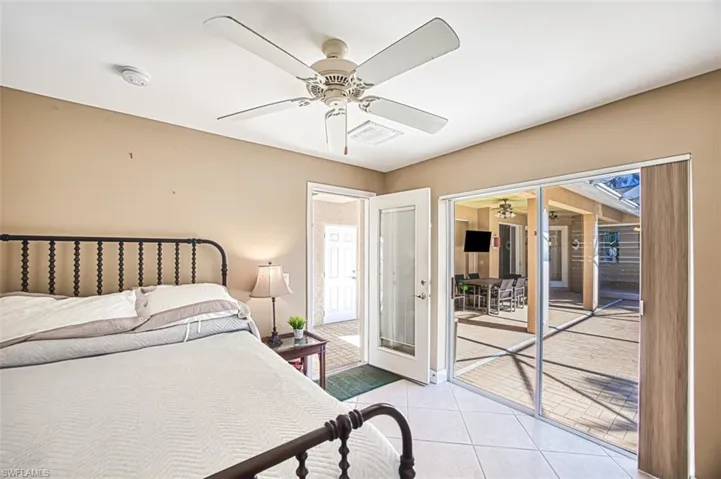 Tiled bedroom featuring access to exterior and ceiling fan