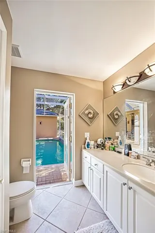 Bathroom featuring tile patterned floors, vanity, and toilet