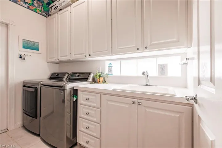 Laundry room with extra storage and sink.