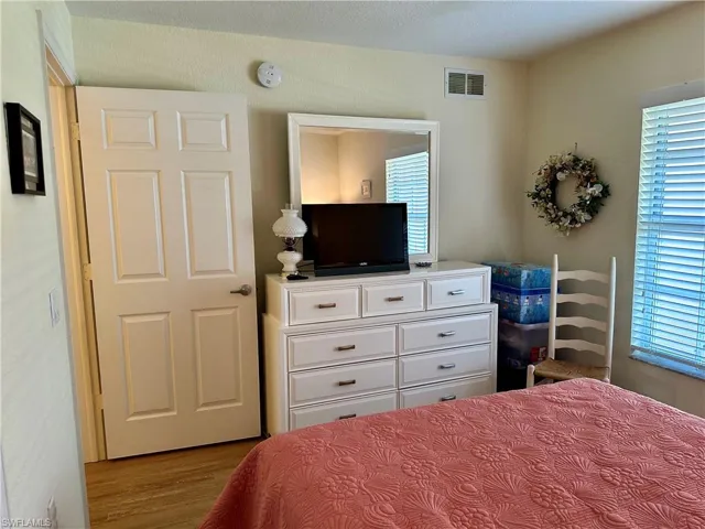 The features include ceiling fan, large closet, queen size bed, dresser, and chair.