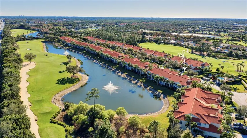 Aerial perspective of suburban area with a golf course and a nearby body of water