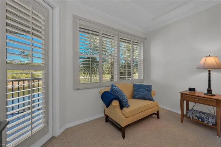 Sitting room with crown molding and carpet floors