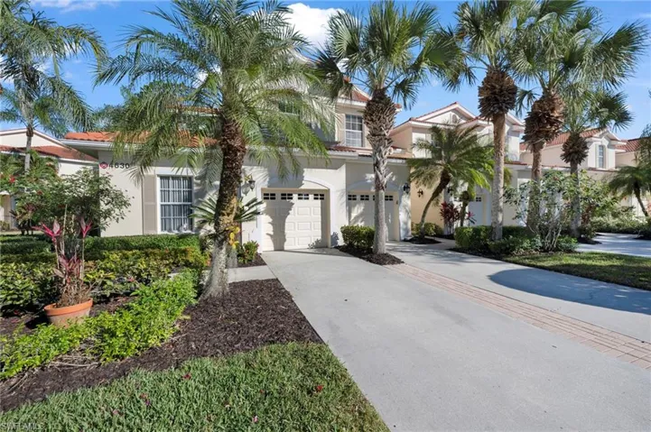 Mediterranean / spanish house with concrete driveway, stucco siding, an attached garage, and a tile roof