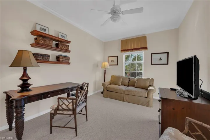 Office area featuring carpet floors, crown molding, and a ceiling fan