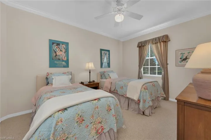 Bedroom with carpet, a ceiling fan, and crown molding