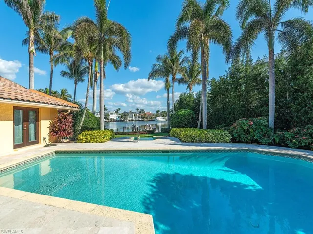 View of pool featuring a water view and french doors