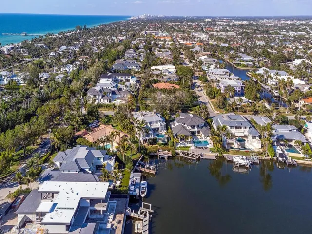 Birds eye view of property with a water view