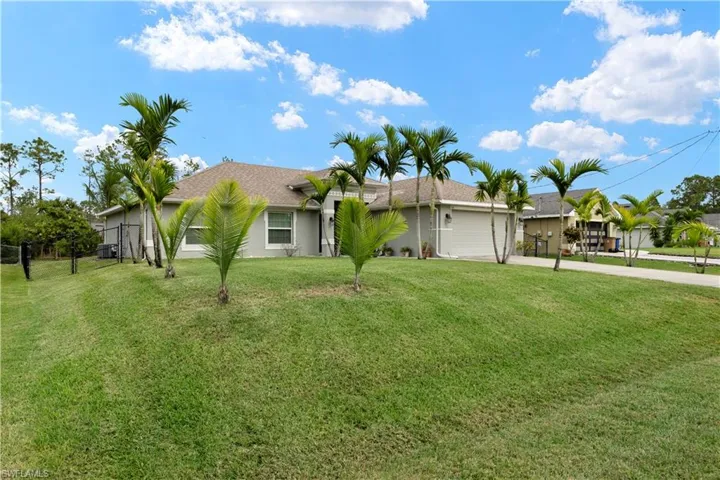 Single story home with concrete driveway, a shingled roof, stucco siding, and a garage