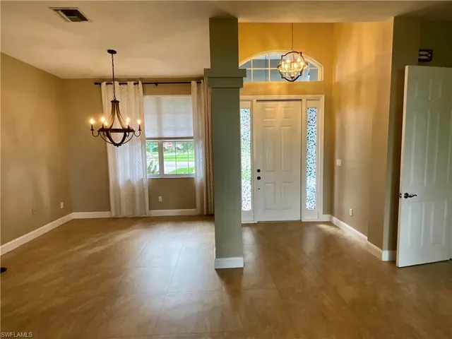 Entryway with a chandelier and light tile patterned floors
