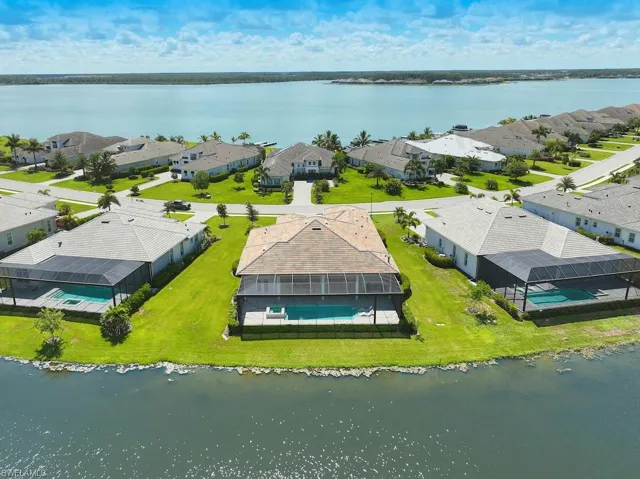 Birds eye view of property with a water view