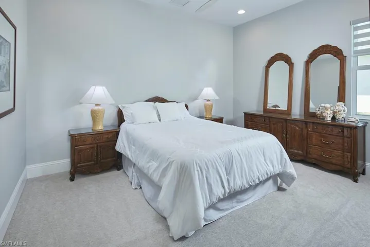 Bedroom featuring light colored carpet