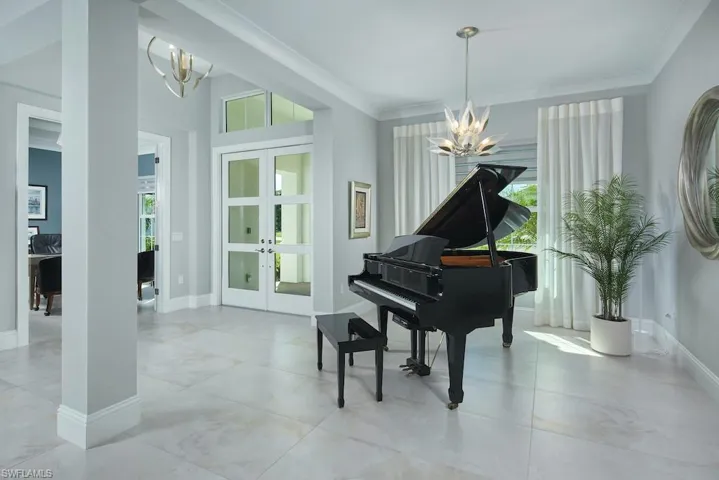 Misc room featuring ornamental molding, an inviting chandelier, and french doors