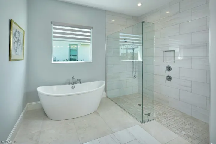 Bathroom with plus walk in shower and tile patterned floors