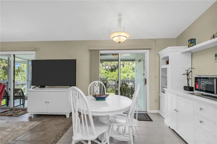 Dining room featuring light tile patterned floors and baseboards