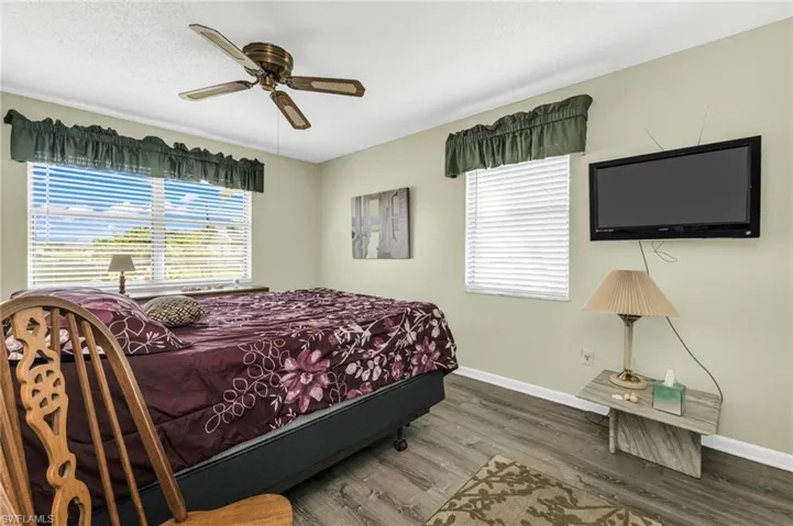 Bedroom featuring wood finished floors, a ceiling fan, and a textured ceiling