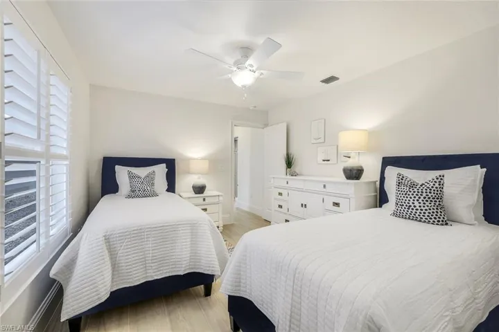 Bedroom with ceiling fan and light hardwood / wood-style flooring