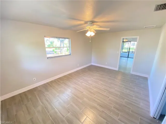 Unfurnished room featuring wood finish floors and a ceiling fan