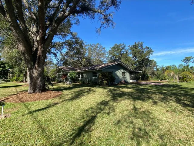 View of property exterior with a yard