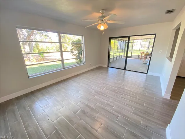 Empty room featuring wood finish floors and a ceiling fan