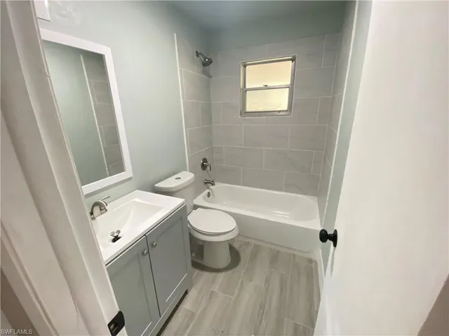Full bath featuring vanity and bathtub / shower combination