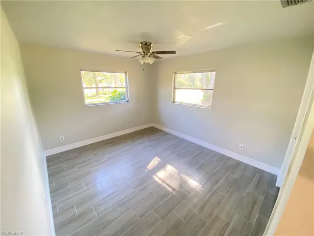Spare room featuring wood finish floors and a ceiling fan