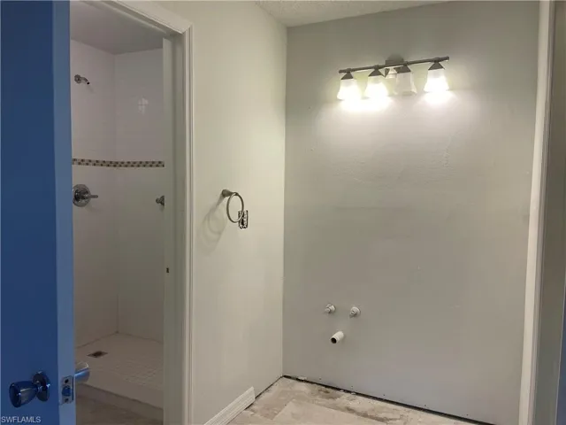 Bathroom featuring a stall shower.  Needs sink and cabinet