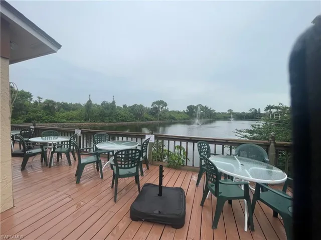 Deck featuring outdoor dining area and a water view