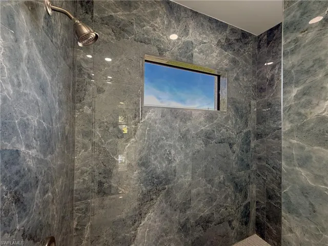 Bathroom featuring a marble finish shower