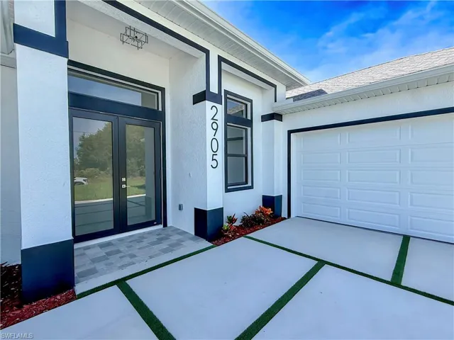 Entrance to property with driveway, stucco siding, roof with shingles, and a garage