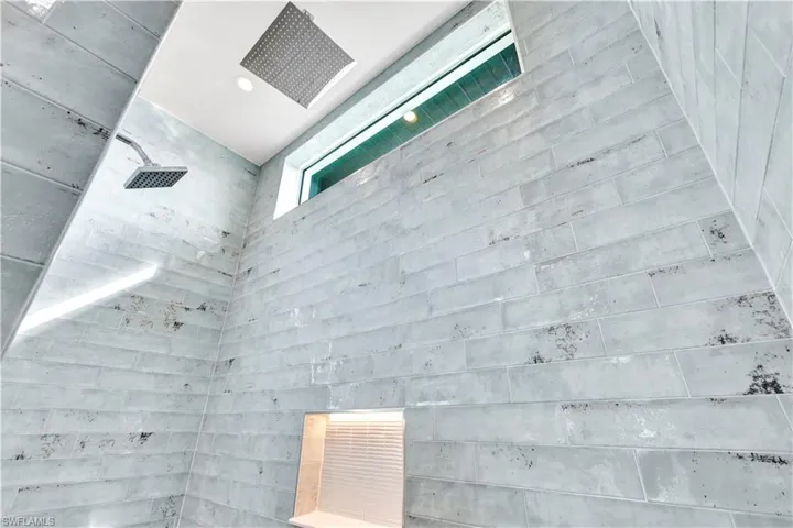 Interior details featuring tiled shower and recessed lighting