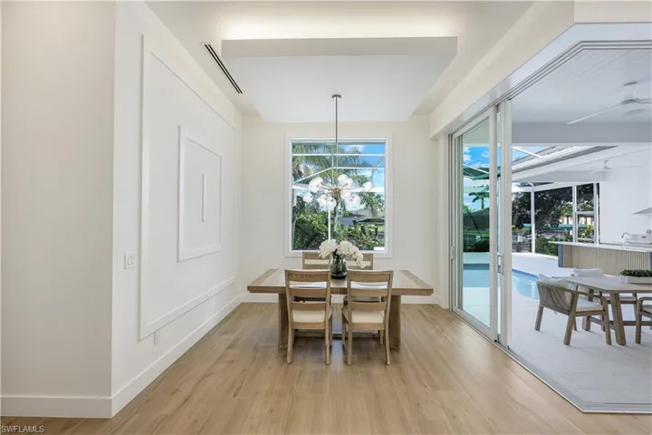 Dining area featuring light wood finished floors, healthy amount of natural light, and baseboards