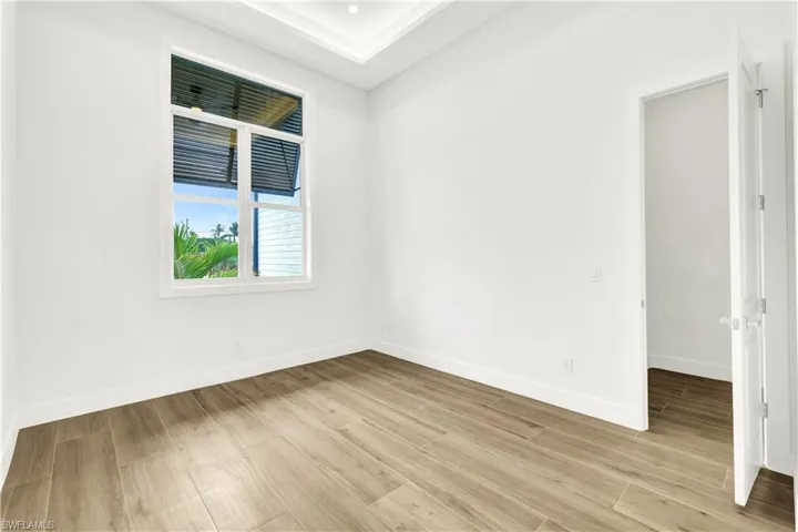 Spare room featuring baseboards and light wood-style flooring