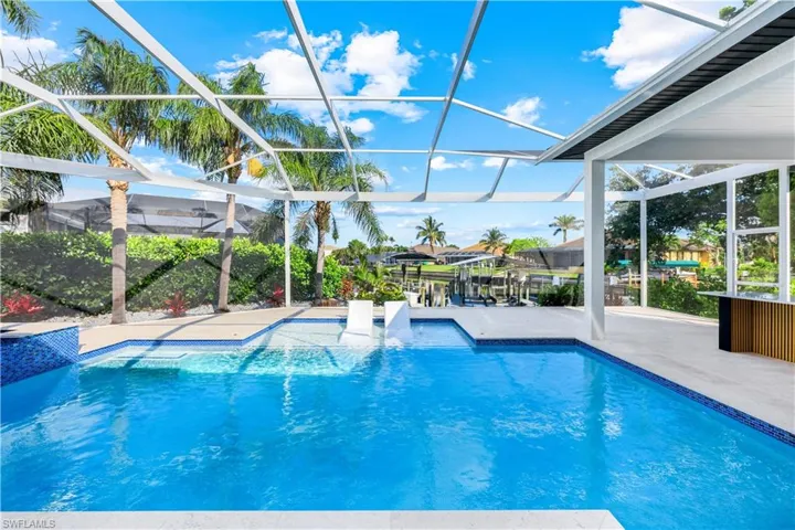 Outdoor pool with glass enclosure and a patio area