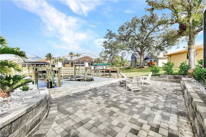 View of patio with boat lift and a boat dock