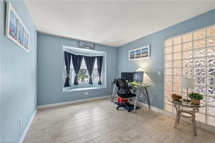 Office area with light hardwood / wood-style flooring